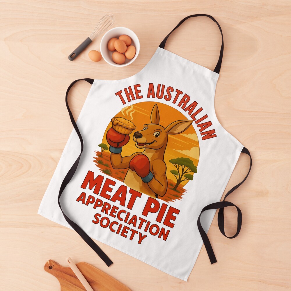Cotton apron featuring boxing kangaroo in gloves holding meat pie beneath glowing orange outback sunset sky