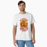 Classic T-shirt showing cartoon boxing kangaroo holding meat pie under orange outback sunset sky