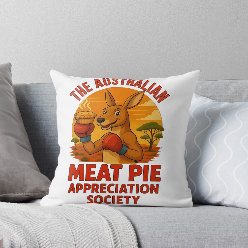 Throw pillow printed with boxing kangaroo raising meat pie against vivid orange outback sunset