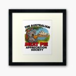 Framed art print of cartoon koala eating meat pie on Sydney Opera House steps with blue harbour skyline