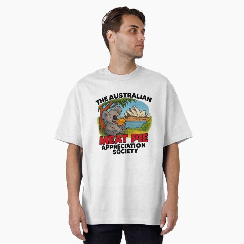 Oversized T-shirt printed with cartoon koala holding hot meat pie on Sydney Opera House steps with blue harbour sky