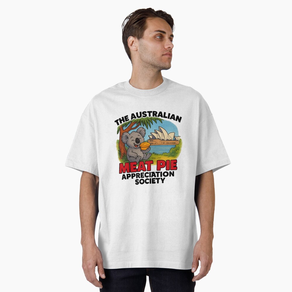 Oversized T-shirt printed with cartoon koala holding hot meat pie on Sydney Opera House steps with blue harbour sky