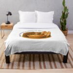 Soft fleece throw blanket printed with golden Aussie meat pie framed by boomerang and surfboard on sandy beach under sunny sky