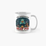 “White ceramic mug printed with UFO beaming up golden Aussie meat pie over bush campfire scene with kangaroo and emu”