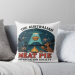 Throw pillow with UFO abducting meat pie over Aussie bush campfire artwork featuring kangaroo and emu