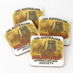 Set of four cork-backed drink coasters printed with cartoon Ned Kelly bushranger in helmet holding hot Aussie meat pie